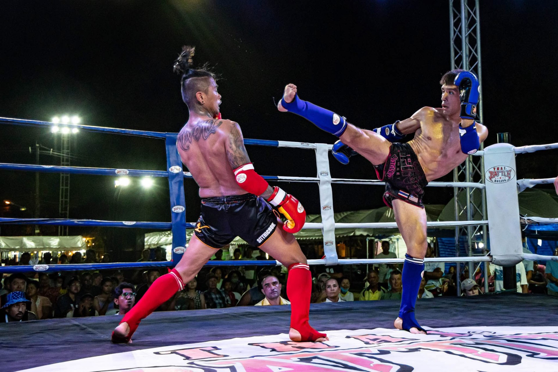 WMO USA fighter landing a high kick against Thai opponent