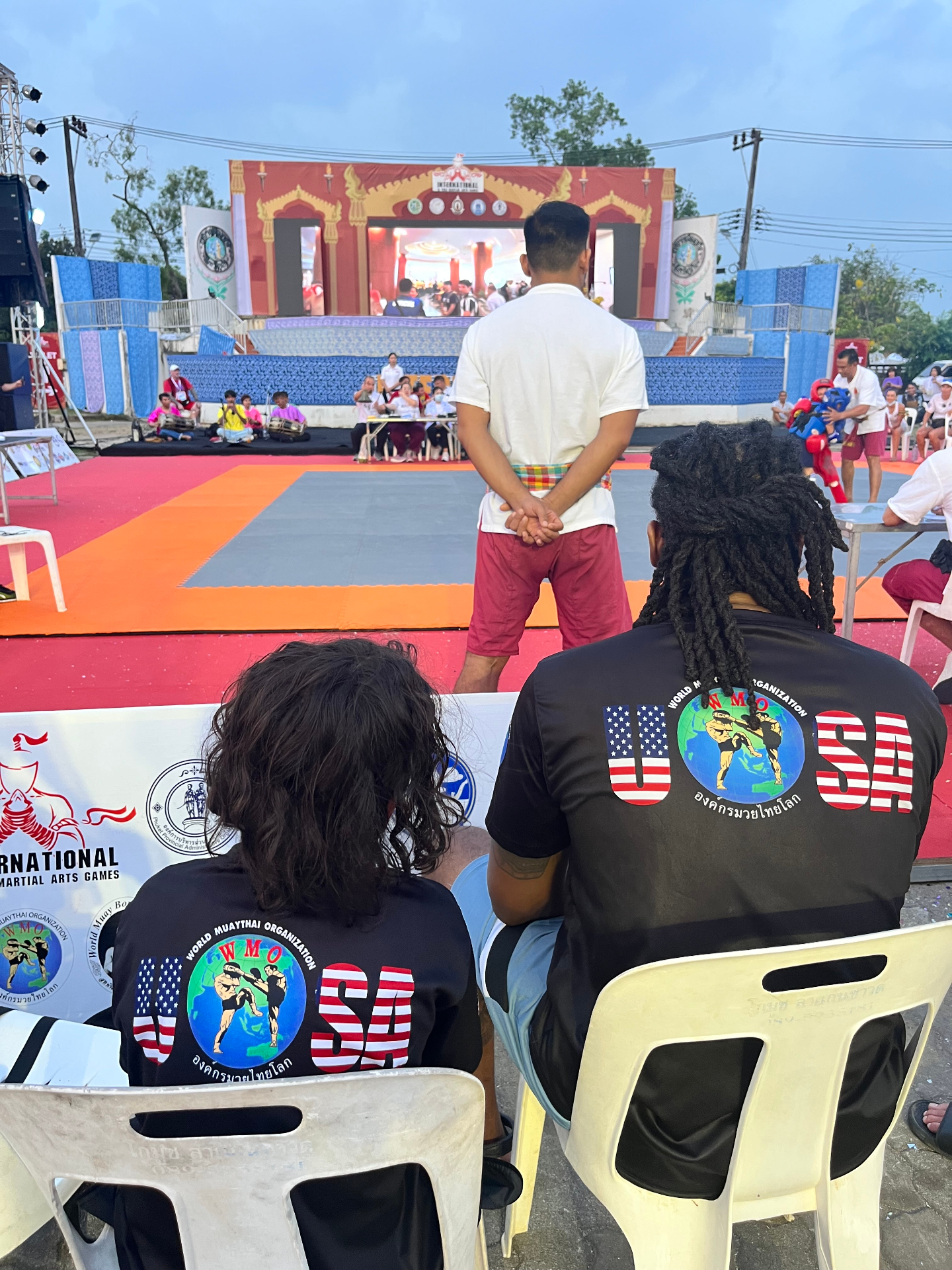Two WMO USA team members in matching USA jerseys watching the mat at the World Championship