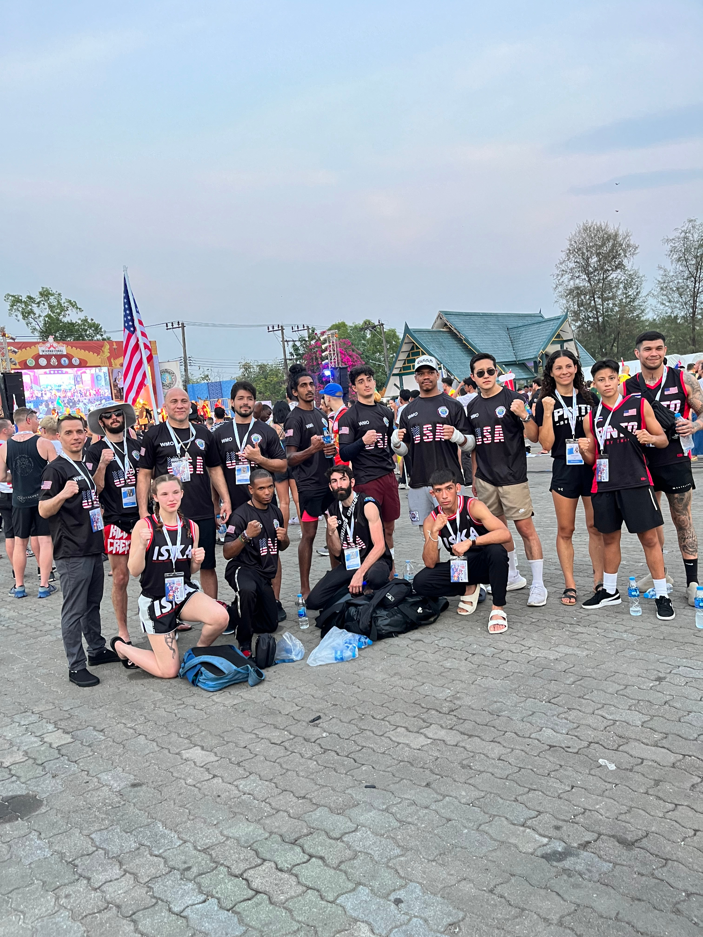 WMO Team USA delegation posing with the American flag at the World Championship in Bangkok