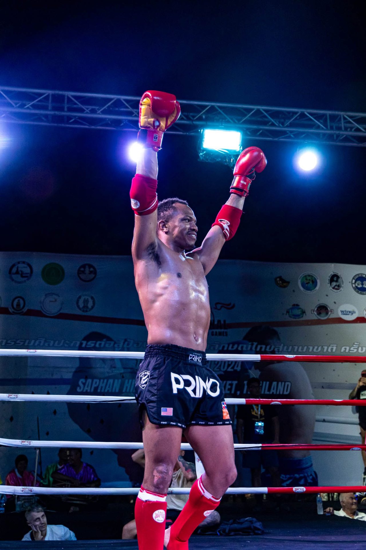 WMO USA fighter celebrating victory with arms raised in the ring