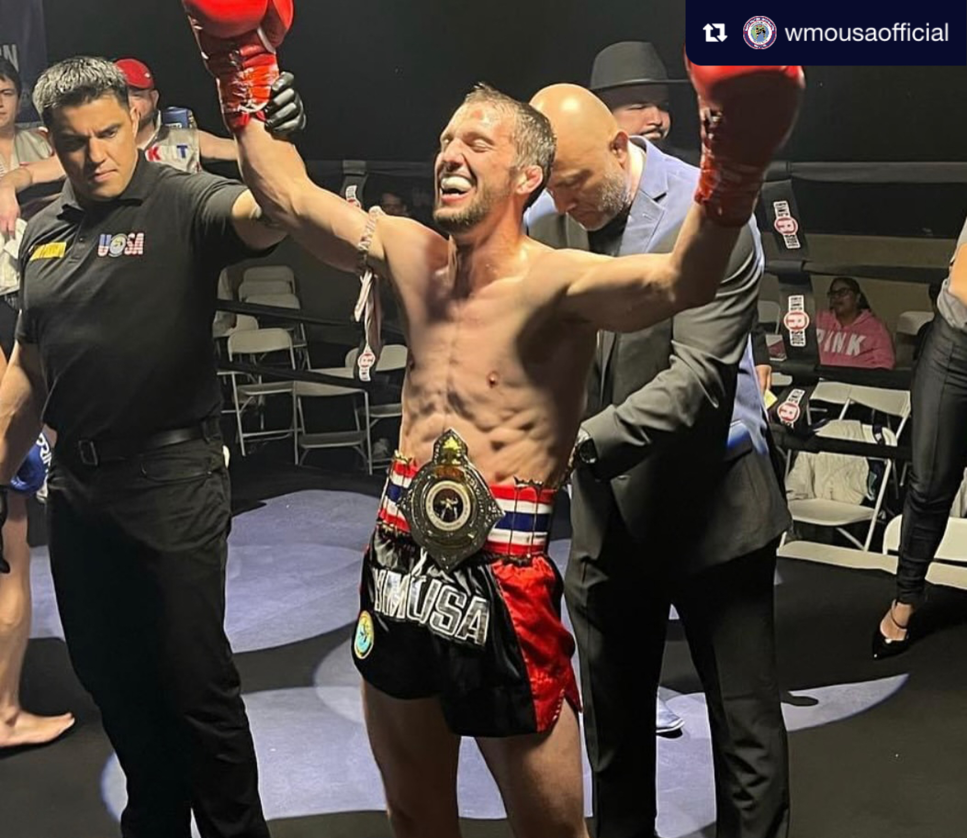 WMO USA champion with arms raised after winning the title belt
