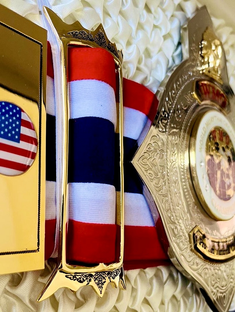 WMO USA championship belt resting on the Thai flag with the USA emblem