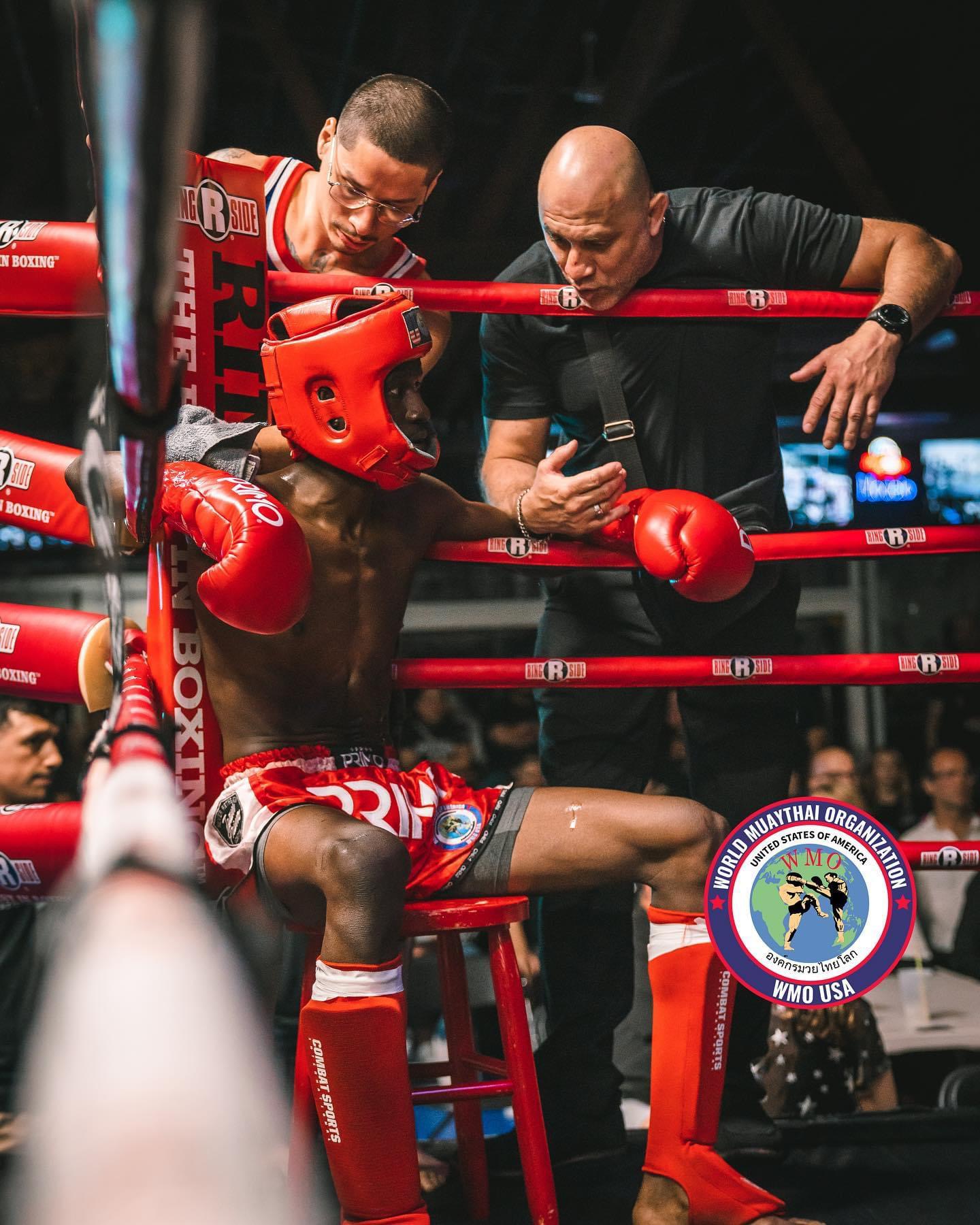 Coach instructing a Muaythai athlete in the corner