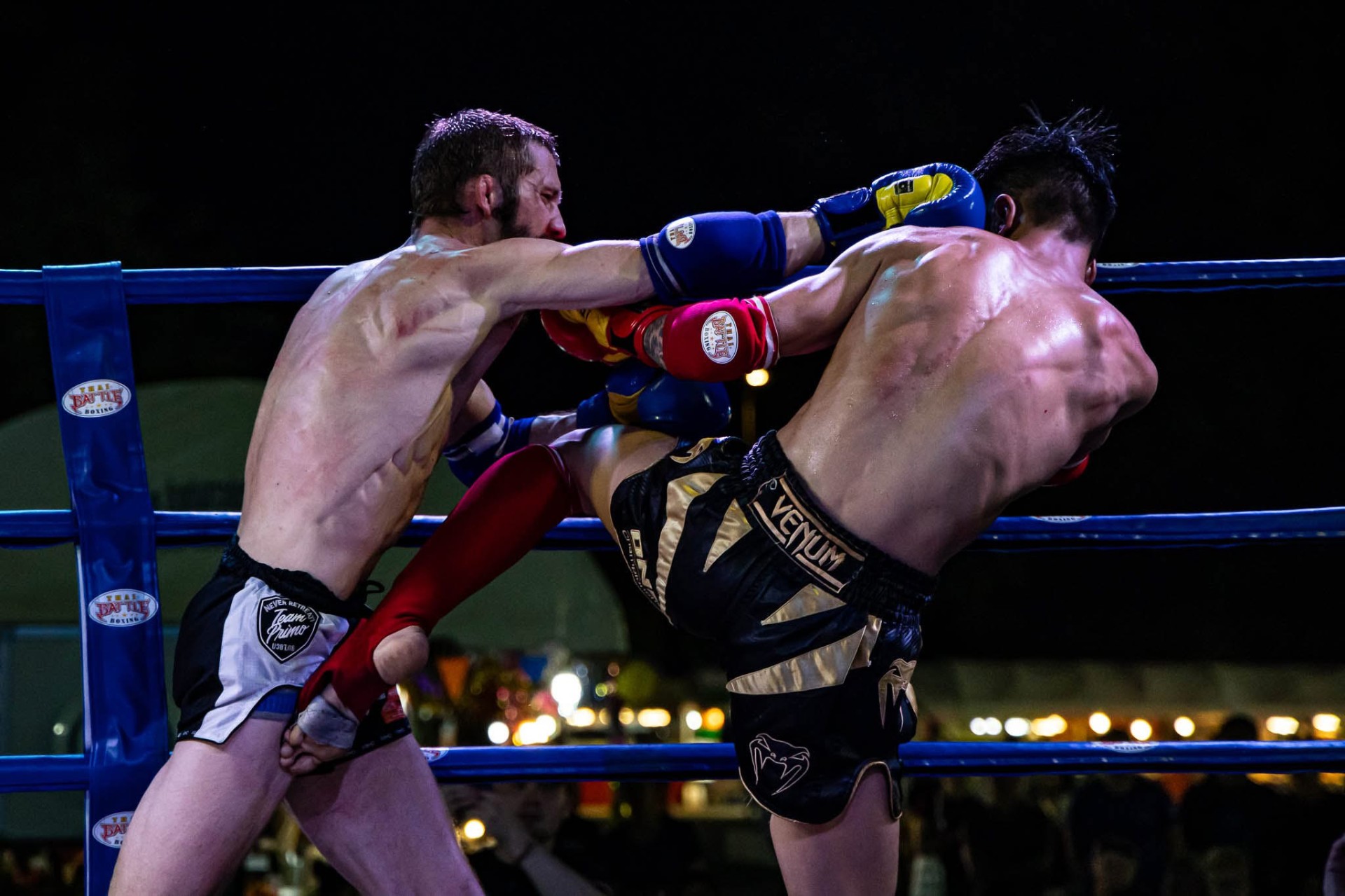 Muaythai fighters exchanging knees and punches