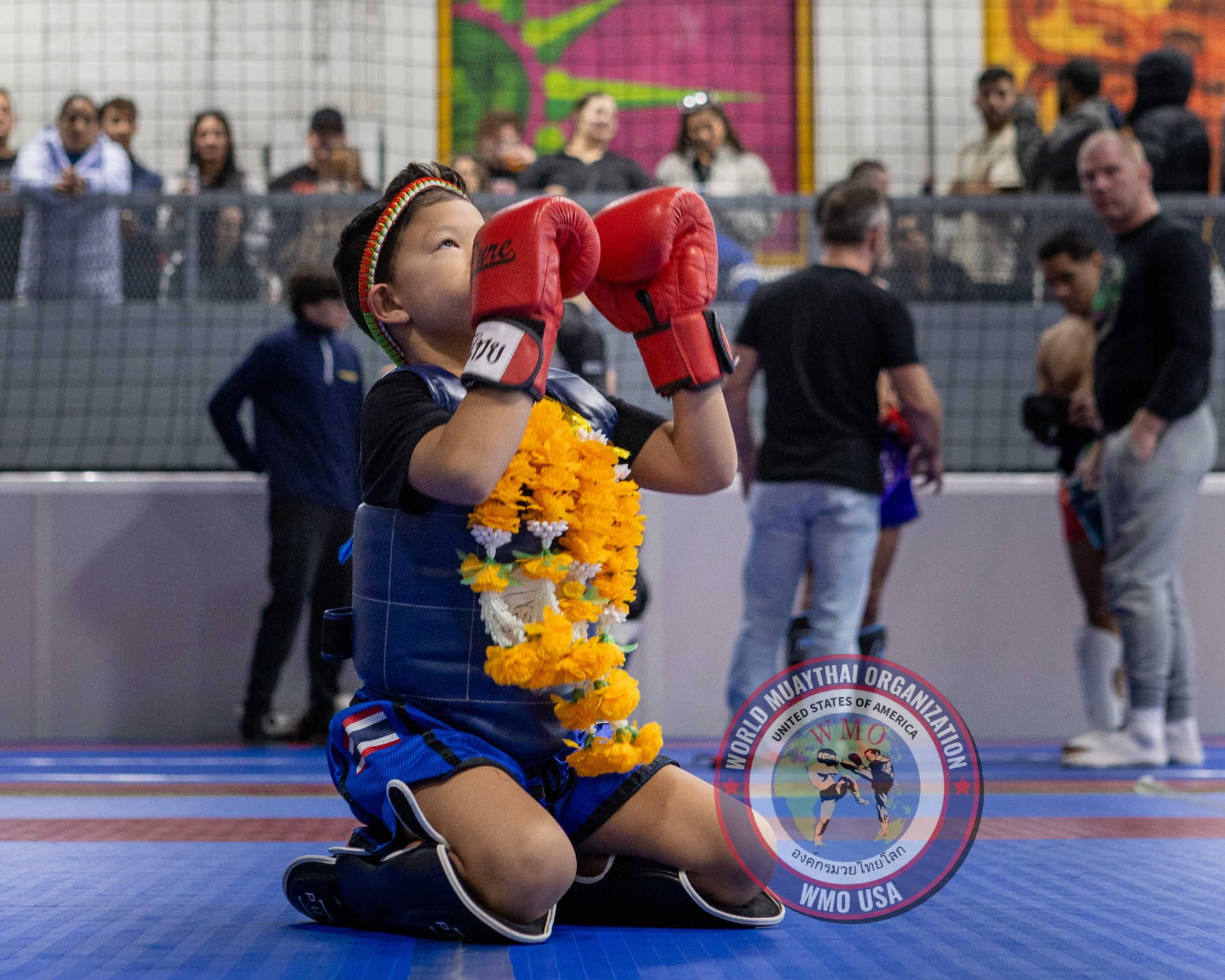 Young Muaythai fighter performing Wai Kru ceremony
