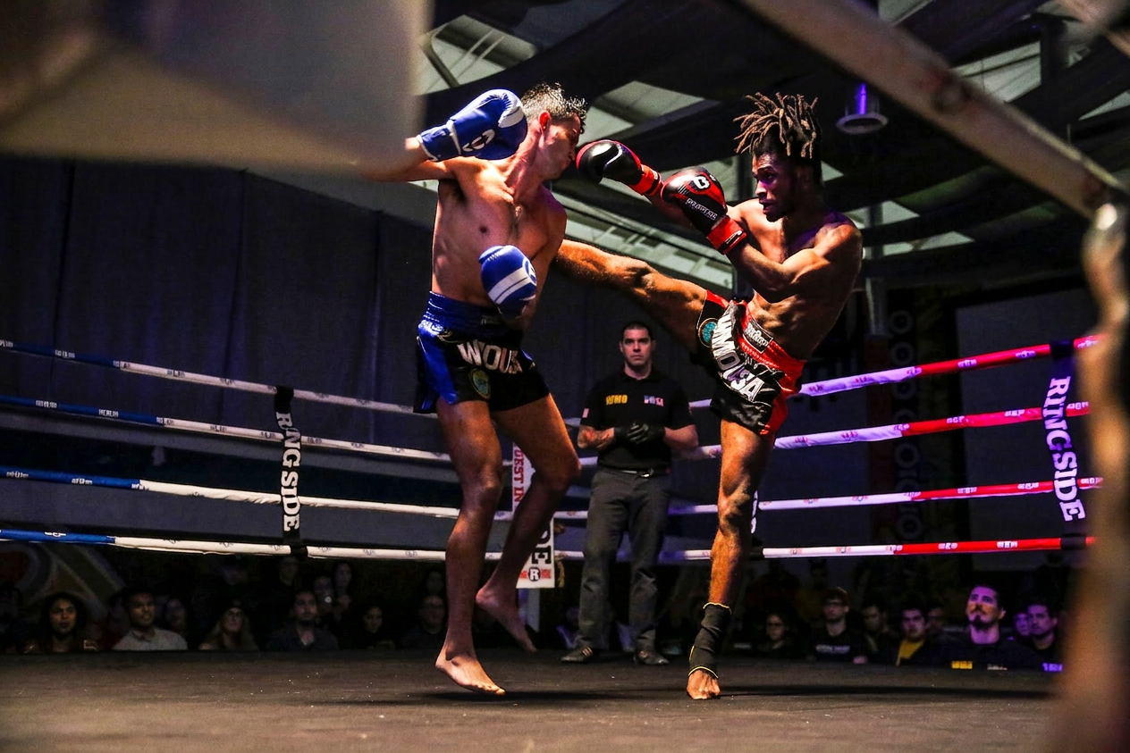 WMO USA fighters exchanging kicks under the lights