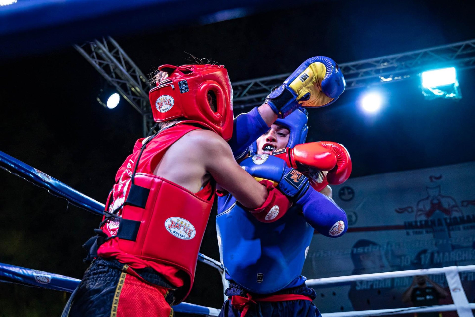 Muaythai fighters exchanging strikes in the ring