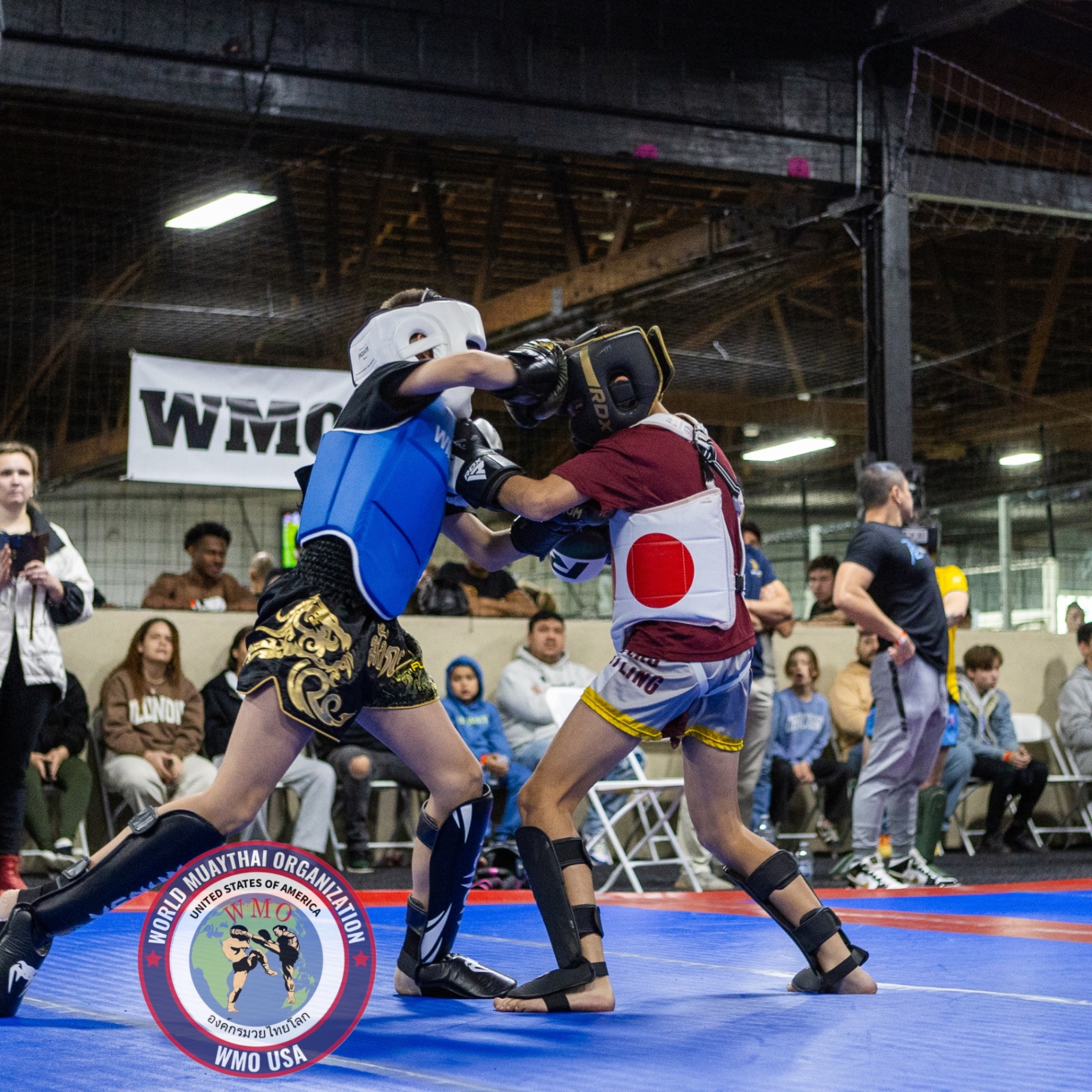 Two young Muaythai athletes in the clinch during a sanctioned bout