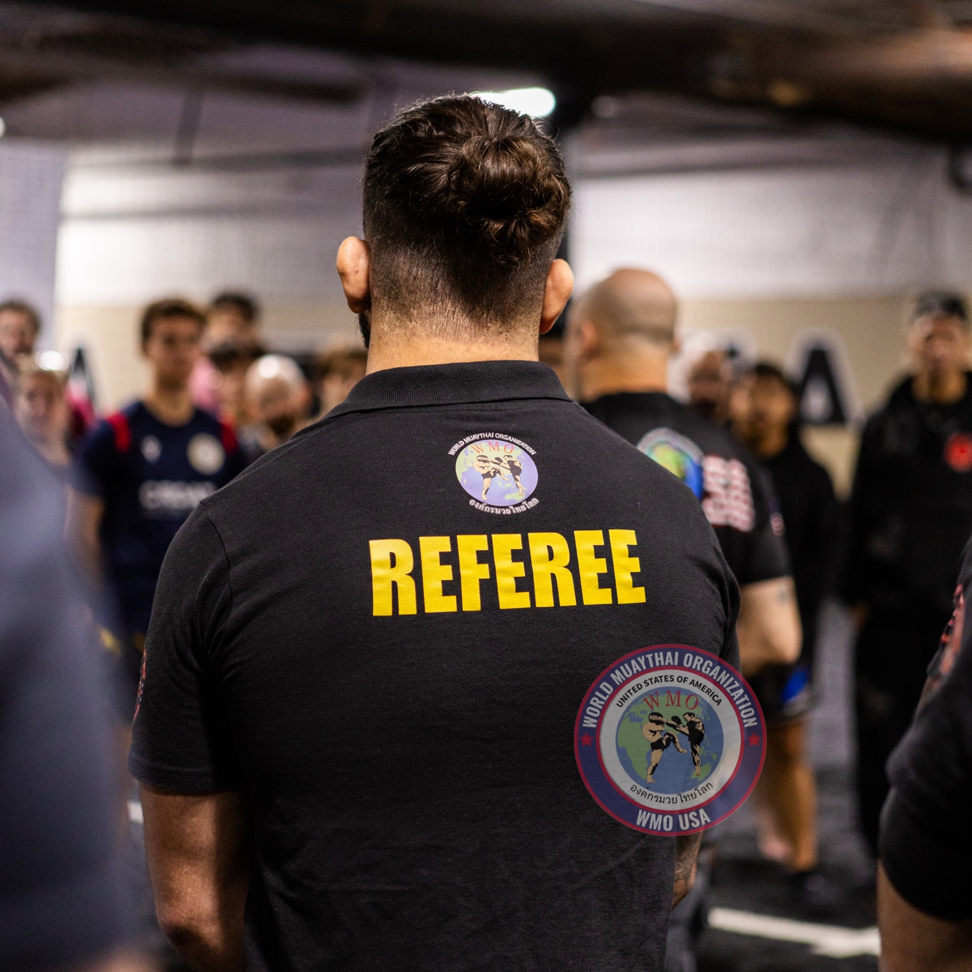 WMO USA referee overseeing the rules meeting before fight night
